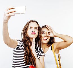 Image showing two best friends teenage girls together having fun, posing emotional on white background, besties happy smiling, lifestyle people concept