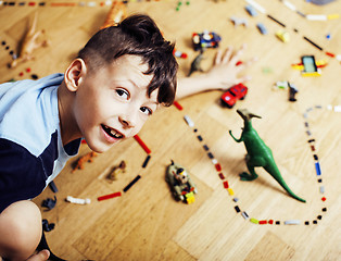 Image showing little cute preschooler boy among toys lego at home happy smiling, lifestyle people concept
