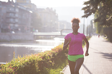 Image showing african american woman jogging in the city