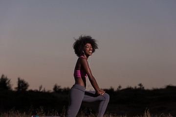 Image showing black woman is doing stretching exercise relaxing and warm up