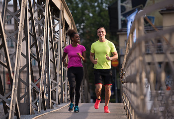 Image showing multiethnic couple jogging in the city