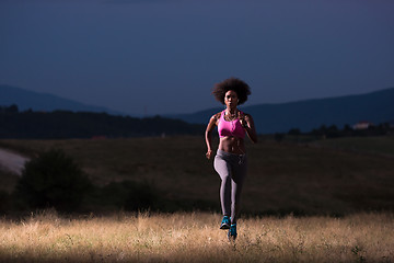 Image showing Young African american woman jogging in nature