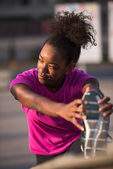 Image showing African American woman doing warming up and stretching