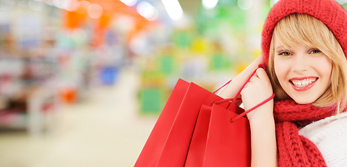 Image showing woman in hat and scarf shopping at supermarket