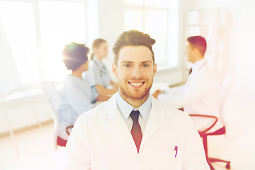 Image showing happy doctor over group of medics at hospital