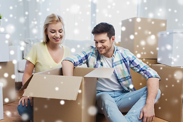 Image showing smiling couple with big boxes moving to new home