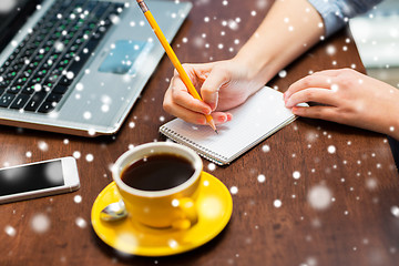 Image showing woman writing to notebook with pencil