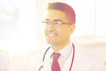 Image showing smiling male doctor in white coat and eyeglasses