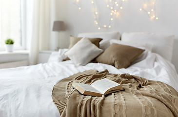 Image showing bedroom with bed and christmas garland at home