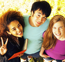 Image showing cute group of teenages at the building of university with books 