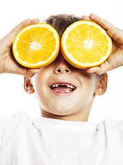 Image showing little cute boy with orange fruit double isolated on white smili