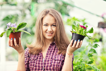 Image showing smiling woman in greenhouse