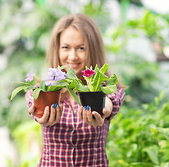 Image showing smiling woman in greenhouse