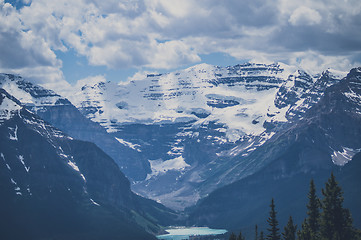 Image showing Mountain peaks with snow and cloudy sky