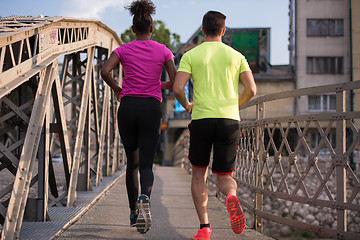 Image showing multiethnic couple jogging in the city