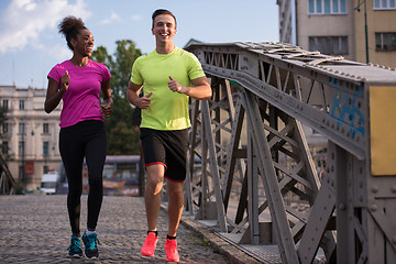 Image showing multiethnic couple jogging in the city