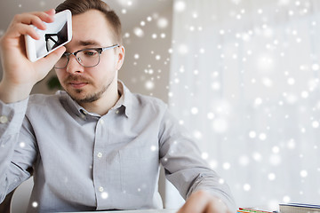 Image showing businessman with smarphone at home office