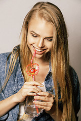 Image showing young blond woman on white backgroung gesture thumbs up, isolate