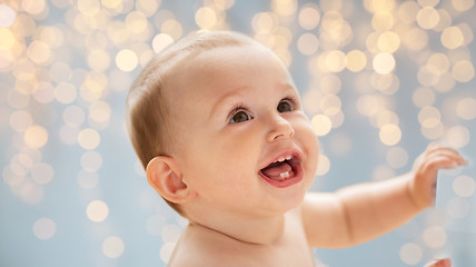 Image showing happy little baby boy or girl looking up