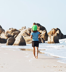 Image showing happy family on beach playing, father with son walking sea coast