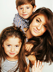 Image showing young mother with two children on white background, happy smiling family indoor, lifestyle people concept
