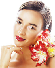 Image showing young pretty brunette woman with red flower amaryllis close up i