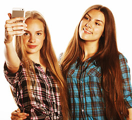 Image showing cute teenage girls making selfie isolated