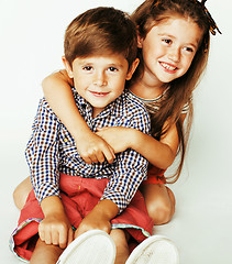 Image showing little cute boy and girl hugging playing on white background, happy family close up isolated, lifestyle people concept