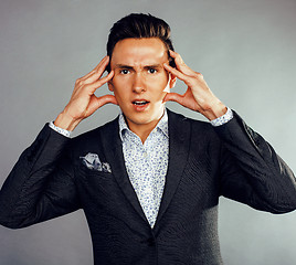 Image showing young pretty business man standing on white background, modern hairstyle, posing emotional, lifestyle people concept