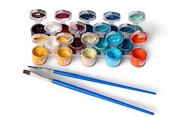 Image showing Set of colorful acrylic paints in jars and two brushes