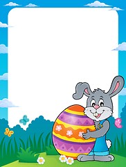 Image showing Frame with bunny holding big Easter egg