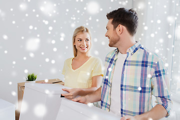 Image showing smiling couple with big boxes moving to new home