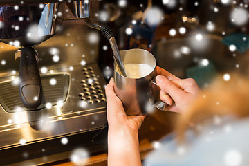 Image showing close up of woman making coffee by machine at cafe