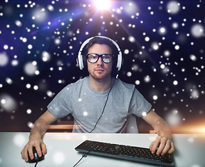 Image showing man in headset playing computer video game