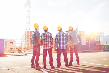 Image showing group of builders in hardhats outdoors