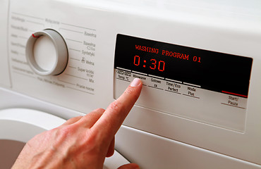 Image showing man hand adjusting washing machine