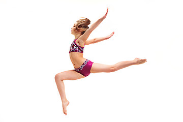 Image showing The teenager girl doing gymnastics exercises isolated on white background