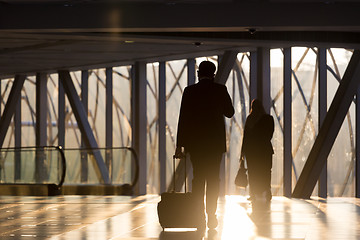 Image showing Businessman at airport corridor walking to departure gates.