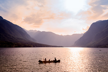 Image showing Family rowing in canoe boat on beautiful lake Bohinj, Slovenia.