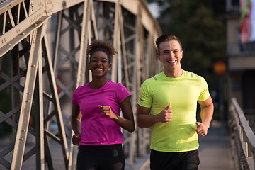 Image showing multiethnic couple jogging in the city