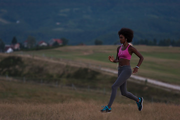 Image showing Young African american woman jogging in nature