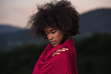 Image showing outdoor portrait of a black woman with a scarf