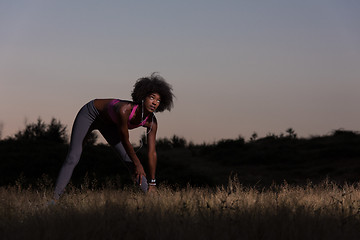 Image showing black woman is doing stretching exercise relaxing and warm up