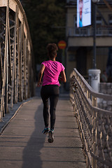 Image showing african american woman running across the bridge