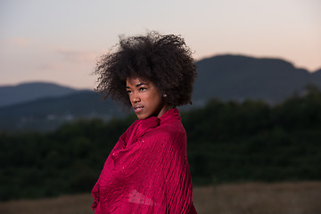 Image showing outdoor portrait of a black woman with a scarf