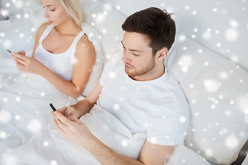 Image showing couple with smartphones in bed