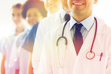 Image showing close up of happy doctors with stethoscope