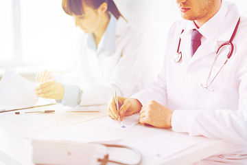 Image showing doctor and nurse writing prescription paper