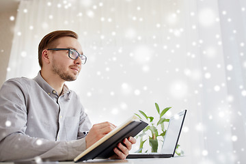 Image showing creative male worker or businessman with notebook