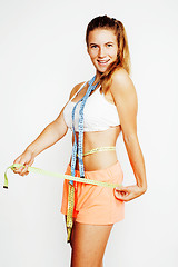 Image showing woman measuring waist with tape on knot like a gift, tan isolated close up white background